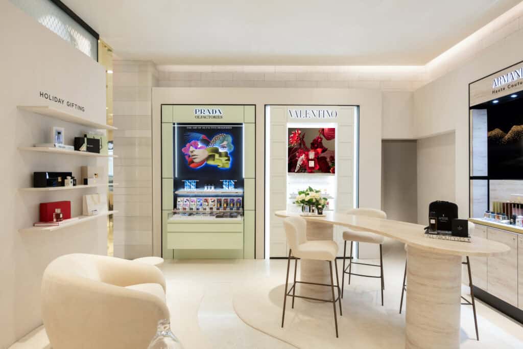 Luxury beauty retail boutique featuring Prada, Valentino, Armani, and Yves Saint Laurent branded shop-in-shop displays photographed inside a department store in Chicago.